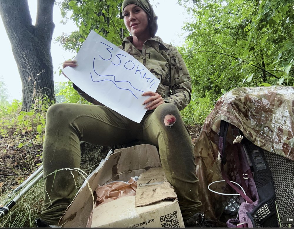 April holding a 350 km milestone sign in Ukraine